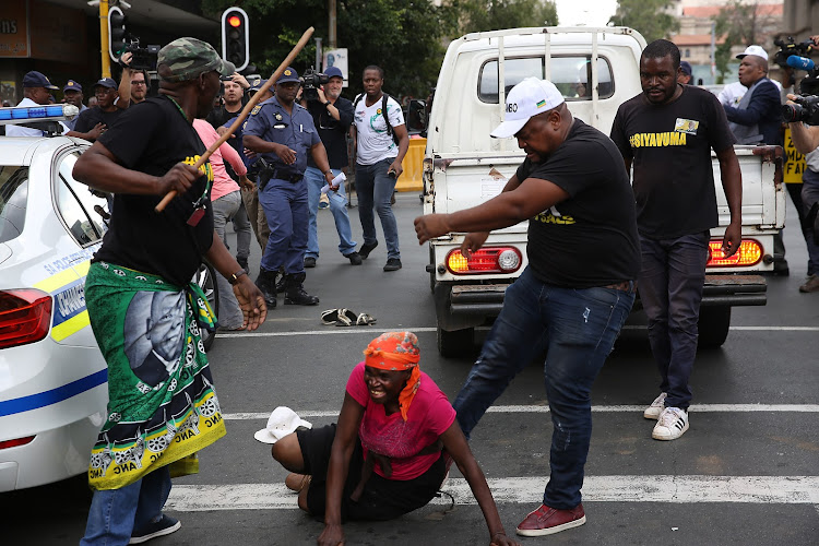 ANC supporters attack a bakkie suspected to be carrying BLF members, outside Luthuli House in Johannesburg on 5 February 2018.