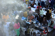Patrons enjoying food and drinks at Kwa mai mai, a commercial center in the Johannesburg CBD.