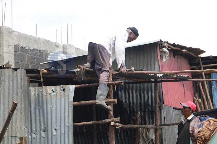 A man constructs a house following the demolitions at Mukuru kwa Reuben on May 6, 2024.