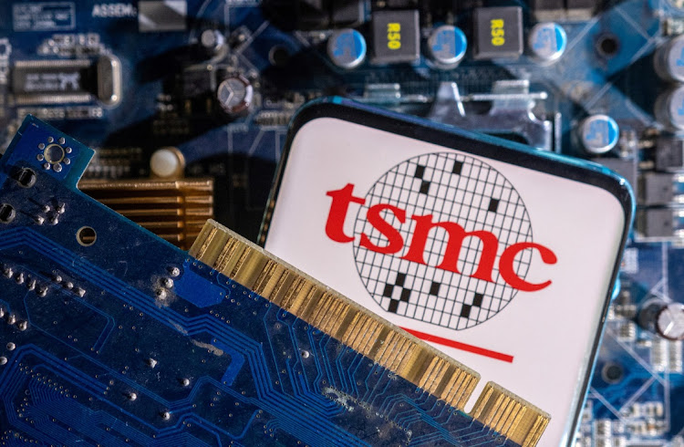 A smartphone with a displayed TSMC (Taiwan Semiconductor Manufacturing Company) logo is placed on a computer motherboard in this illustration. Picture: DADO RUVIC