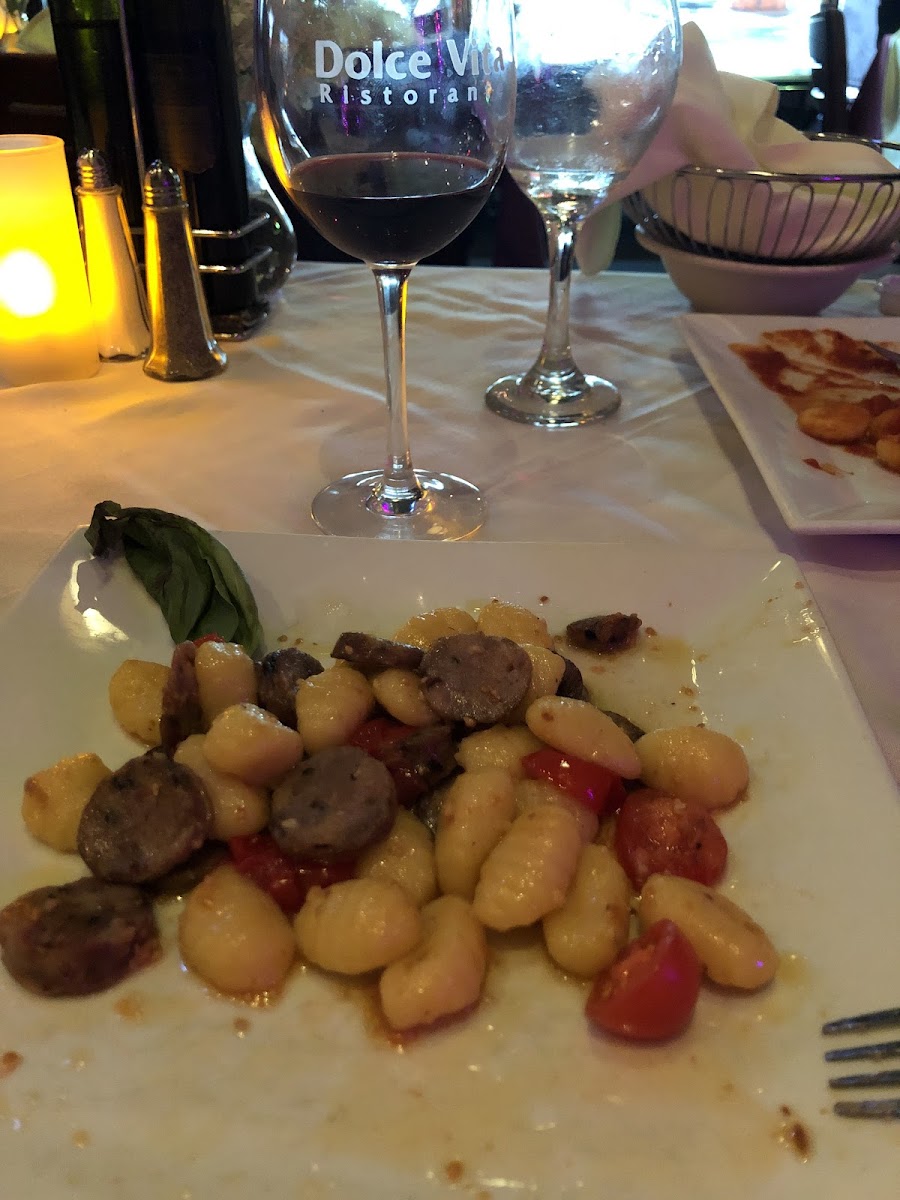 Gluten free gnocchi with a garlic and olive , Italian sausage, and cherry tomatoes!