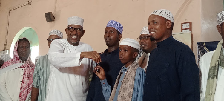 Defense Cabinet secretary Aden Duale hands over car keys to Suheid Aden Hassan emerged the overall winner in Garissa County Quran competition.