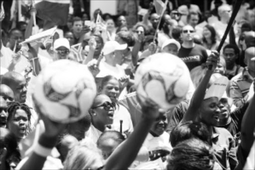 UNITED: Bafana Bafana supporters during the celebrations to mark 100 days before the kickoff of the World Cup in Sandton yesterday. Pic: MOHAU MOFOKENG. 02/03/2010. © Sowetan.