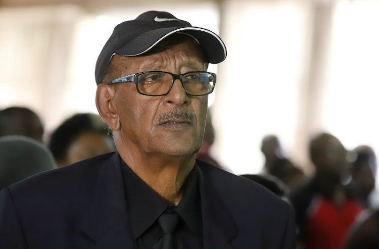 Getachew Tesema, 80, the father of Ethiopian Airline Flight ET302 pilot Yared Getachew, attends the prayer session, as they mourn their relatives during a commemoration ceremony for the victims at the scene of the plane crash.