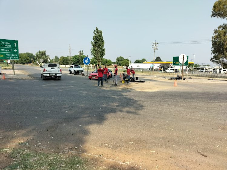 Private workers repair a section of the R708 at the entrance to Clocolan. Picture: SUPPLIED.