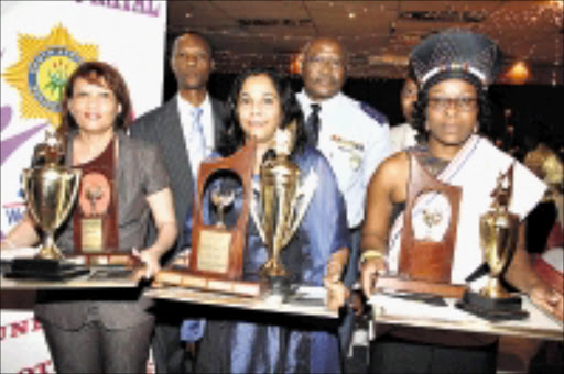 COMMENDED: KwaZulu-Natal SAPS Women's Network Second Annual Prestige Award winners are, from left, first runner-up Superintendent E Timalo, overrall winner Inspector Miriam Vanker and second runner-up Superintendent B Mgenge. In the back row are community police forum chairman M Sibisi and commissioner Hamilton Ngidi. 02/11/08. Pic. Thuli Dlamini. © Sowetan.