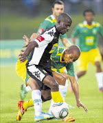 IN A TUSSLE: Kingston Nkhatha holds off  Siyabonga Nkosi during the Absa Premiership match between Golden Arrows and Black Leopards at Princess Magogo Stadium  in Durban last night.  Photo:  Gallo Images