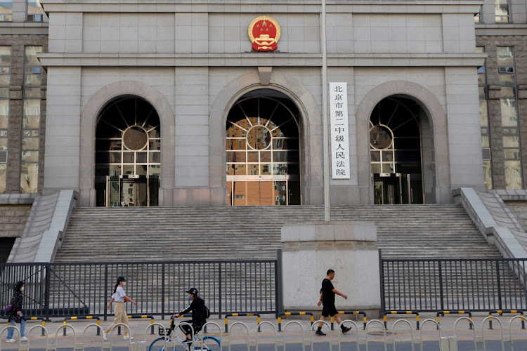 People walk past one of the entrances of Beijing No. 2 Intermediate People's Court where Australian writer Yang Hengjun is expected to face trial on espionage charges, in Beijing, China May 27, 2021.