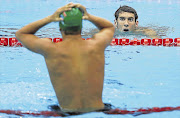 Michael Phelps, right, of the US passes Chad le Clos of South Africa after the latter won gold in the men's 200m butterfly final on Tuesday at the 2012 Olympic Games in London, England Picture: EZRA SHAW/GALLO IMAGES