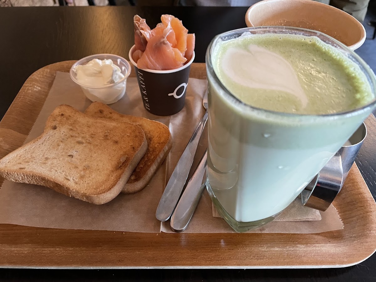 Gf bread with cream cheese and smoked salmon, matcha latte and hot coffee