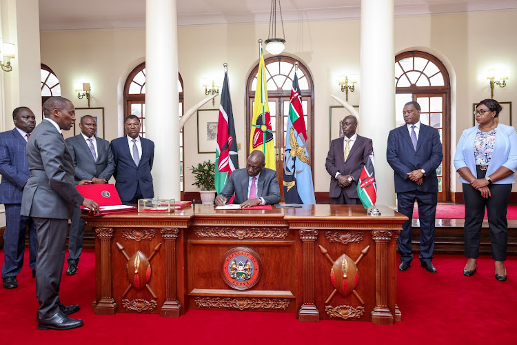 President William Ruto assenting to law two bills at State House, Nairobi on December 11, 2023