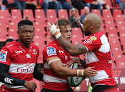 Andries Coetzee of the Lions (c) celebrates a try with teammate Lionel Mapoe (r) during the 2018 Super Rugby match between the Lions and the Sunwolves at Ellis Park, Johannesburg on 17 March 2018.
