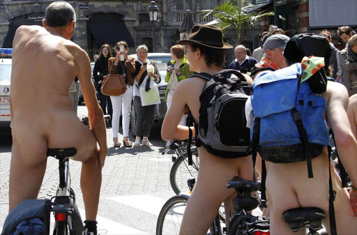 Pedestrians take photographs of cyclists during the World Naked Bike Ride in Brussels June 18, 2011. This annual manifestation is performed to demand more respect for cyclists on the streets and to promote the bike as an alternative non-polluting transportation vehicle. REUTERS/Francois Lenoir