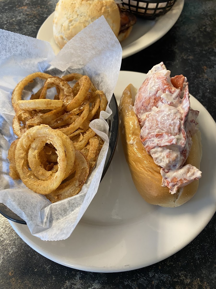 Gluten free onion rings and lobster roll on a gf roll.