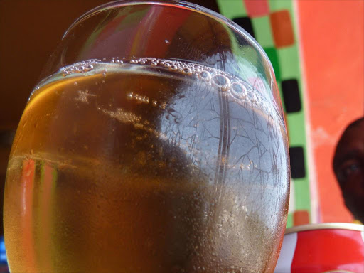 A man enjoys an alcoholic drink at a bar in Mombasa in this undated photo. /ELKANA JACOB