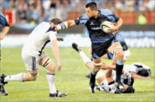 CAN'T TOUCH: Pierre Spies leaves Josh Blackie helpless during the Super 14 match between the Bulls and Auckland Blues at Loftus Stadium in Pretoria. 21/02/09. Pic. Lee Warren. © Gallo Images.