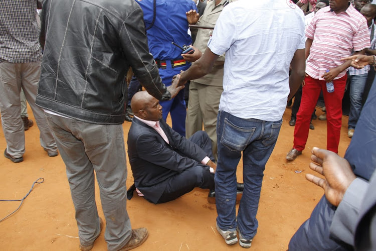 Gatundu South MP Moses Kuria sits on the ground to avoid being ejected from the Kitui BBI forum on Saturday, February 1, 2020