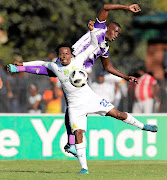 Sundowns' Percy Tau  and Maritzburg's Siyanda Xulu in a tussle during the Nedbank Cup semifinal clash at Harry Gwala Stadium yesterday.