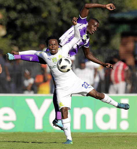 Sundowns' Percy Tau and Maritzburg's Siyanda Xulu in a tussle during the Nedbank Cup semifinal clash at Harry Gwala Stadium yesterday.