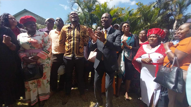 Music Copyright Society of Kenya CEO Ezekiel Mutua join members in singing Solomon Mukubwa (L) song during an AGM at Maanzoni Lodge in Athi River, Machakos, on February 16, 2024.