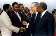 UN secretary-general Boutros Boutros-Ghali (second from right) accompanied by Rwandan Prime Minister Faustine Twaglramungu (R) greets cabinet ministers July 13 1995 upon arrival at the airport at the start of his two day visit to the country.