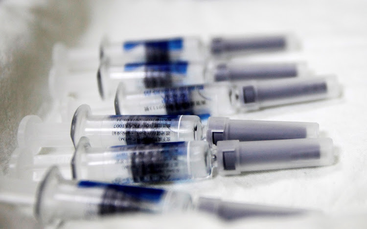 Vaccines are placed on a tray in preparation for the start of the flu season.