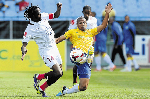 NO MATCH: Lerato Chabangu of Swallows battles for the ball with Bryce Moon of Sundowns during the PSL match at Loftus Stadium yesterday Picture: