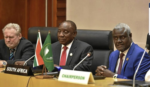 President Cyril Ramaphosa, flanked by former SA trade and industry minister Rob Davies and the African Union Commission chairperson Moussa Faki Mahamat, is now AU chair.