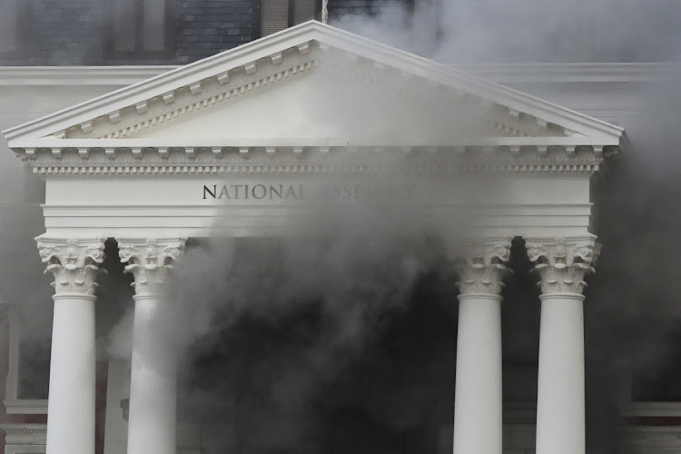 Smoke rises after a fire broke out at Parliament.