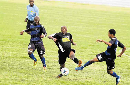 HEAVY ODDS: Tornado player Lucky Sikhosana is outnumbered as he tries to find a way past Buffalo FC players during their match at Buffalo City Stadium last Friday MICHAEL PINYANA