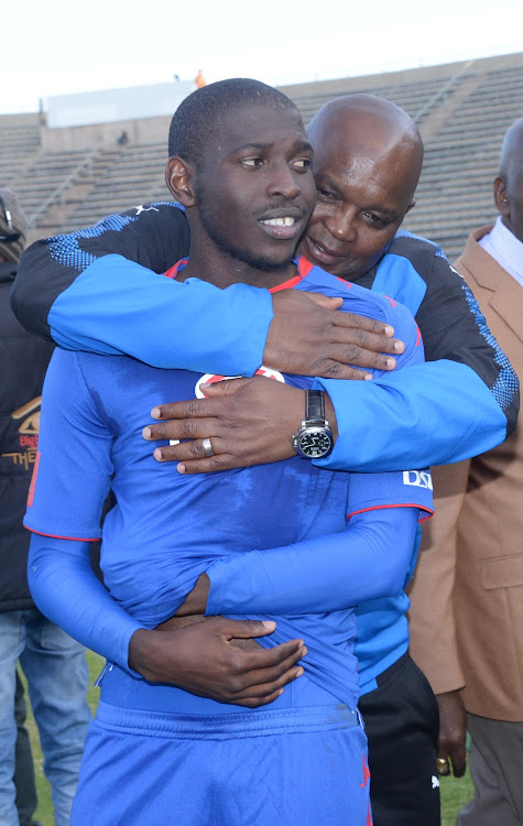 Pitso Mosimane embrace SuperSport United player Aubrey Modiba after a match.