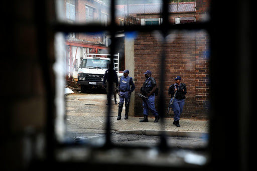 FEBRUARY 27, 2017. Fear and tension were palpable in the inner city, near the Jeppe Hostel. Numerous shops, have shut their doors in the areas of Small and Jeppe streets as the threats of xenophobic violence gains traction. Several shops were looted in the area last night. Today police went on patrols through the area. PHOTOGRAPH: ALON SKUY/THE TIMES