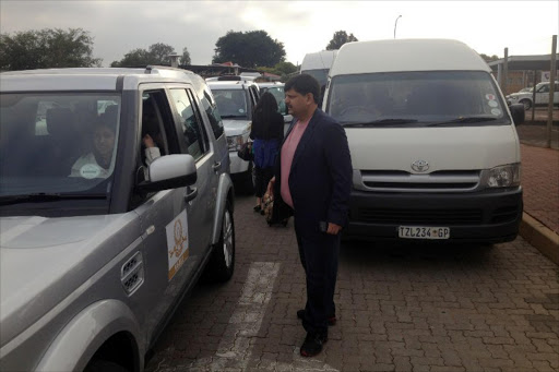 A picture courtesy of Eye Witness News (EWN) on May 2, 2013 shows Atul Gupta welcoming guests arriving at the Waterkloof Airforce Base, oustide Pretoria, for the Gupta wedding on April 30, 2013.