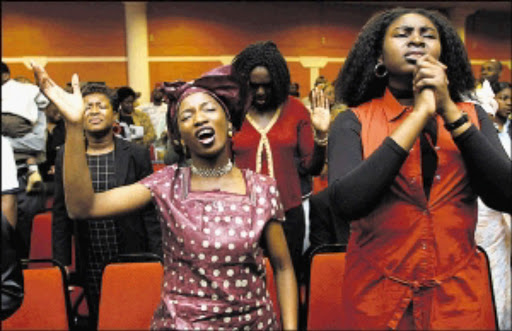 HIGH PRAISE: A group of women during a praise and worship church service.
