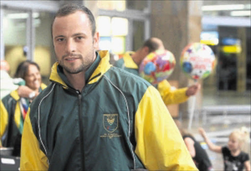 HERO TO ... Oscar Pistorius when he arrived at OR Tambo International Airport in January last year with the rest of the SA Paralympic team from the IPC Athletics World Championships in Christchurch, New Zealand. He is now facing a charge of murder. PHOTO: Sydney Seshibedi