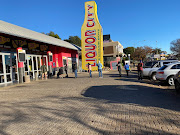 Ten people and counting standing in a queue outside the Liquor City in Northcliff, with masks on and clear social distancing measures in sight - and camp chairs.