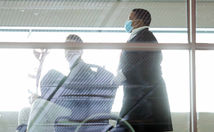 People at Cape Town International Airport wear face masks on March 6 2020.