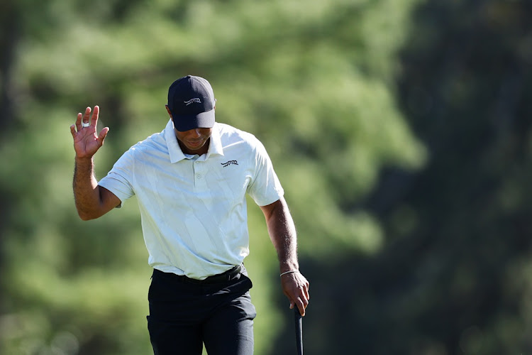 Tiger Woods of the US acknowledges the crowd walking to the 18th green in Saturday third round of the 2024 Masters at Augusta National Golf Club in Augusta, Georgia.