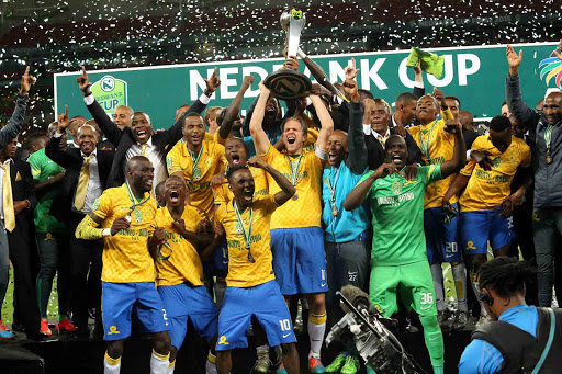 SEVEN YEARS LATER: Triumphant Nedbank Cup winners Mamelodi Sundowns after their match against Ajax on Saturday at the Nelson Mandela Bay Stadium. The team took the trophy after beating Ajax 4-3 on penalties Picture: EUGENE COETZEE