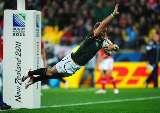 Francois Hougaard of South Africa celebrates as he dives over the line to score his team's second try during the IRB 2011 Rugby World Cup Pool D match between South Africa and Wales on September 11, 2011 in Wellington, New Zealand