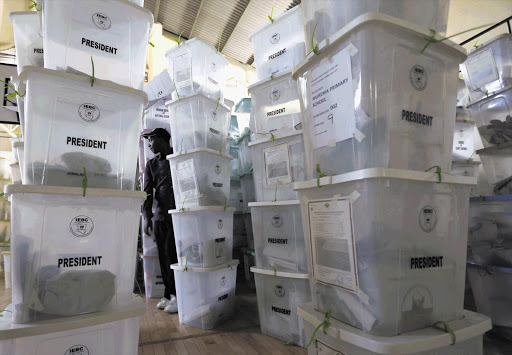 An official from the Independent Electoral and Boundaries Commission inspects ballot boxes at Kasarani gymnasium in Nairobi, Kenya. The election brought out millions of voters despite pockets of violence that killed at least 15 people