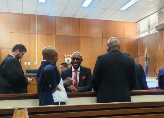 Ex-Eskom boss Matshela Koko and two of his co-accused share a joke during one of the adjournments on Thursday.
