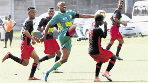 SURROUNDED: Masixole Loli of Future Tigers tries to win the ball from a group of Tornado players during their ABC Motsepe League game at the North End Stadium, East London, on Saturday. Tornado won 5-2 Picture: MICHAEL PINYANA