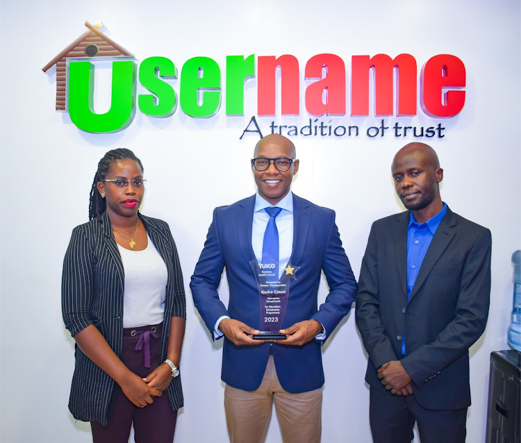 Reuben Kimani, CEO Username Investments holding a trophy for an award won as a Kenyan Changemaker by TUKO Business Leaders Award. Beside him is Julia Majale, MD TUKO and Jacob Otieno, Managing Editor, TUKO