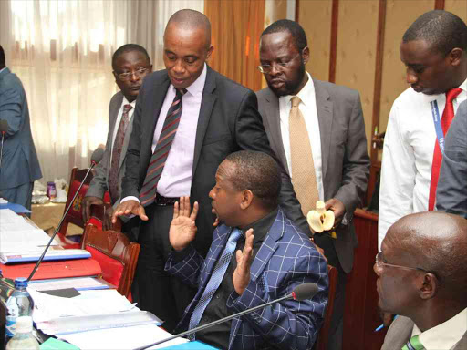 Nairobi Senator Mike Sonko is calmed by Senate Public Accounts Committee members during a meeting where Governor Evas Kidero was summoned on June 15. Sonko disrupted the meeting after calling Kidero a murderer / MONICAH MWANGI