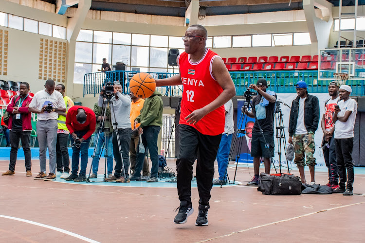 ICT CS Eliud Owalo dribbles the ball during the Eliud Owalo Foundation Basketball tournament launch at Nyayo auditorium on May 1, 2024