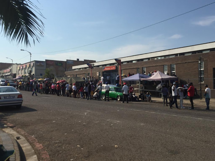 People wait outside a post office in Durban. Most of them are there to check the status of their special Covid-19 grants, which provide R350 per month.