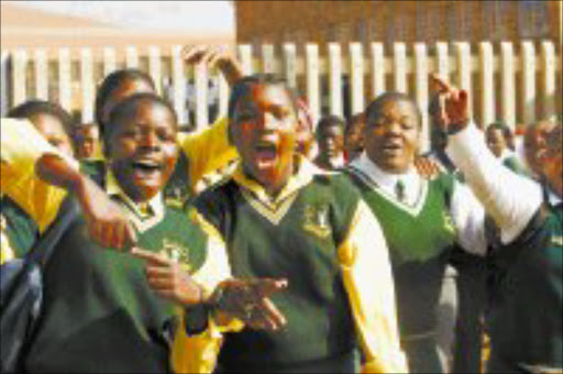 UP IN ARMS: Zonkizizwe informal settlement pupils demonstrate at Winile Secondary School for the opening of their new secondary school, Zonkizizwe. Pic. Antonio Muchave. 15/04/08. © Sowetan.