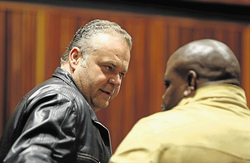 COPPED: Radovan Krejcir and his co-accused, former Hawks Warrant Officer Modise 'Saddam' Maropeng, at the Palm Ridge Magistrate's Court. File photo.