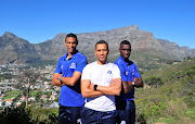 Maritzburg United head coach Fadlu Davids in flanked by his centre-back pairing of Siyanda Xulu (R) and Bevan Fransman (L) at Signal Hill in Cape Town on May 14 2018. 
